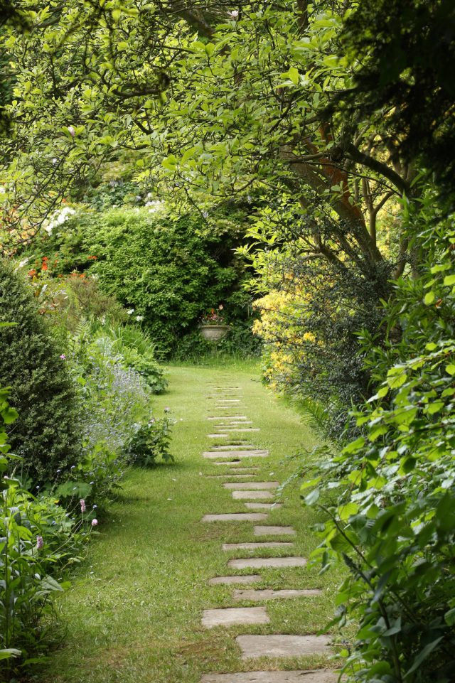 Garden path made of stone slabs in the grass